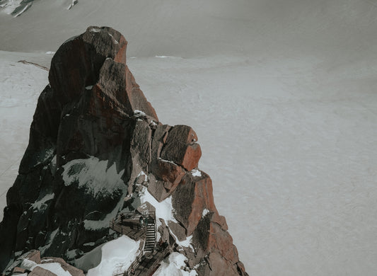 a man riding skis down the side of a snow covered mountain